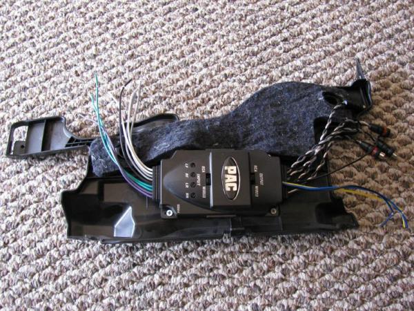 Here's the line output converter mounted onto a panel that is up above the foot pedals and behind the panel below the steering wheel. It is close to the back of the radio (about 24 inches away) and is hidden by another panel when everything is back together again.