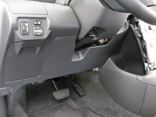 I removed the access panel directly below the steering wheel and behind it is a panel parallel to the floor that I mounted the line output converter to. Works great and everything is hidden.