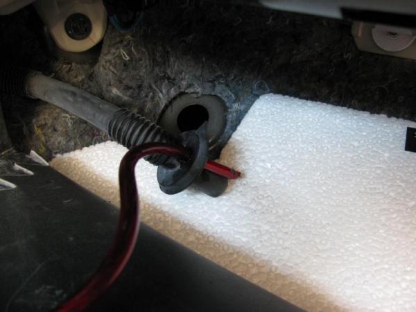 I drilled a hole in the rubber grommet and then angle cut the wire and put a little grease on it to help get it through the hole. Very snug and does not impact the vent tube.