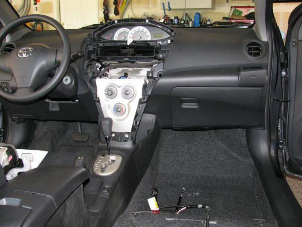 Passenger front seat and radio removed. Now to find a way to get the power lead for the amp through the firewall.