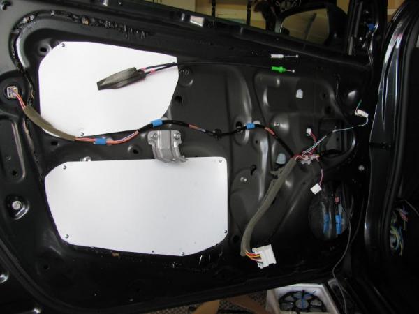 Plastic "For Sale" signs trimmed and sheet metal screwed to the door panel. Interior of door already deadened.