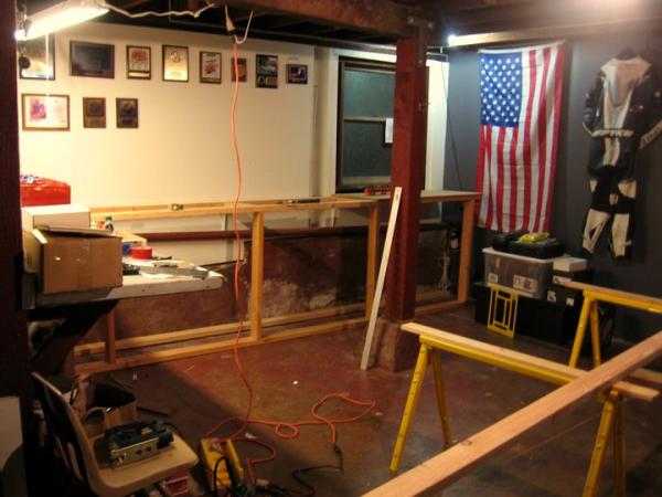 Bought a nice 1922 house in San Francisco in 2009. Building the garage to accomdate my motorsport "lifestyle".
This is a 13'x18" work bench complete with cabinet space to hold plastic bins. Top of bench is left over Pergo laminate from the room I built in the garage. Super strong! Can easily hold a motorcycle motor.